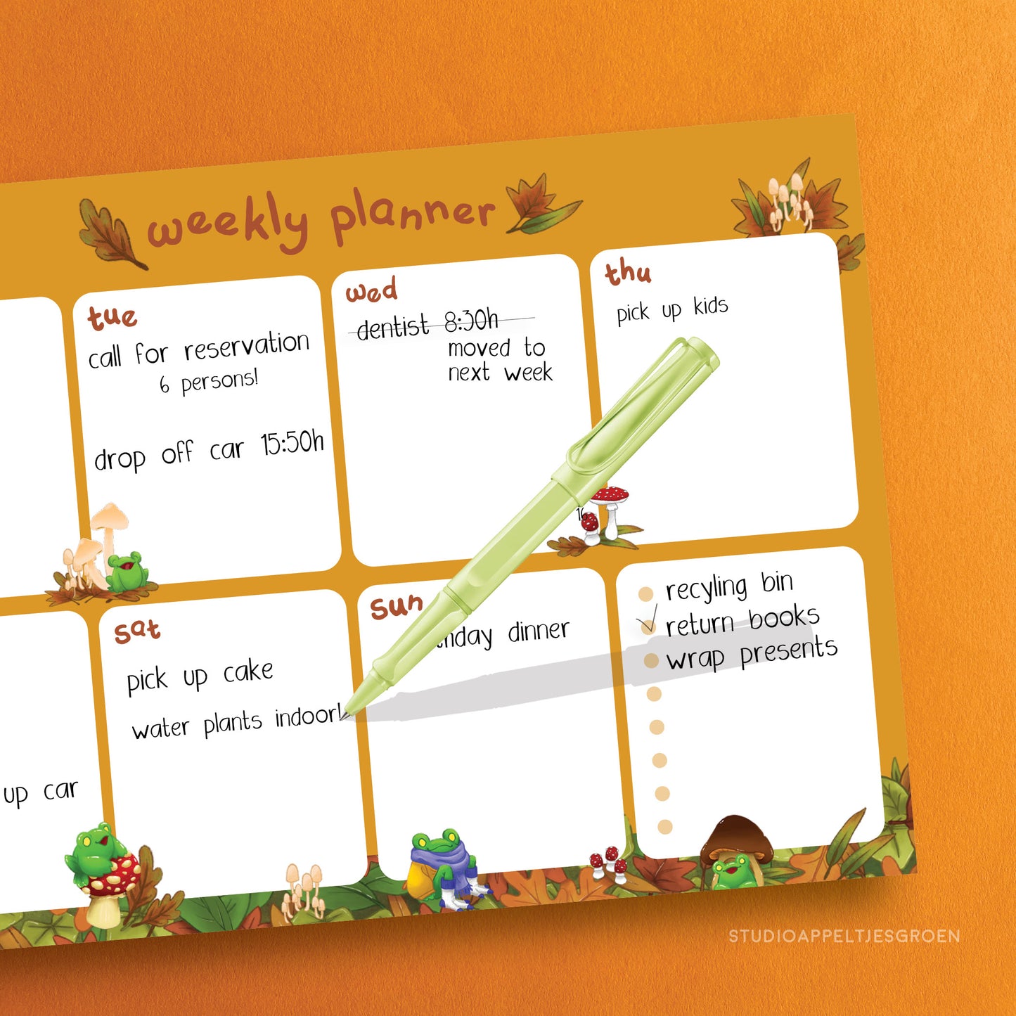 Monthly planner with mushrooms and frogs as decoration, filled in as an example.